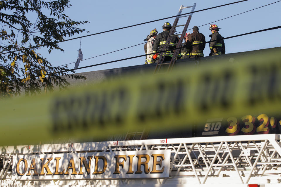 OAKLAND, CA - DECEMBER 03:  Firefighters investigate the scene of a overnight fire that claimed the lives of at least nine people at a warehouse in the Fruitvale neighborhood on December 3, 2016 in Oakland, California. The warehouse was hosting an electronic music party.  (Photo by Elijah Nouvelage/Getty Images)