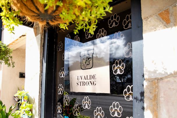 PHOTO: A sign with the 'Uvalde Strong' message and a Uvalde High School Coyote logo is displayed on the window of a building in downtown Uvalde, Texas, on Aug. 21, 2022. (Kat Caulderwood/ABC News)