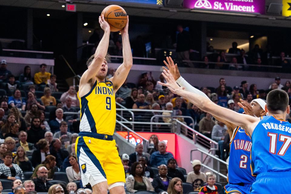 Indiana Pacers guard T.J. McConnell (9) shoots the ball while Oklahoma City Thunder guard Shai Gilgeous-Alexander (2) defends in the first quarter at Gainbridge Fieldhouse in Indianapolis on March 31, 2023.