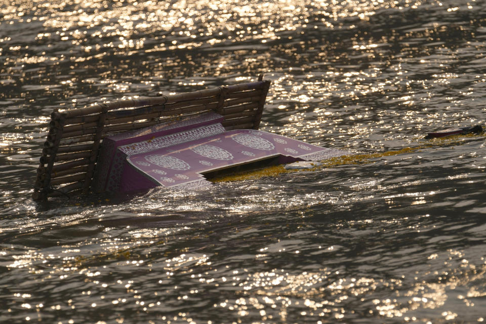 The makeshift boat carrying the ashes of Duangphet Phromthep sinks into the Mekong River in Chiang Rai Province Thailand, Monday, March 6, 2023. Duangphet was one of the 12 boys rescued from a flooded cave in 2018. He died in the U.K. last month. (AP Photo /Sakchai Lalit)