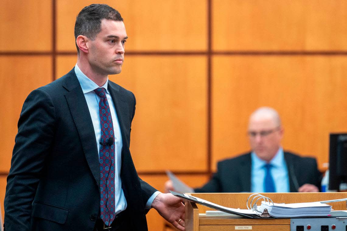 After handing Tacoma Police Department Det. Chad Lawless a piece of evidence, Nick Gross, a defense attorney for Pierce County Sheriff Ed Troyer, walks back to the podium to continue his cross examination of Lawless on Wednesday, Dec. 7, 2022, in Pierce County District Court in Tacoma, Wash.