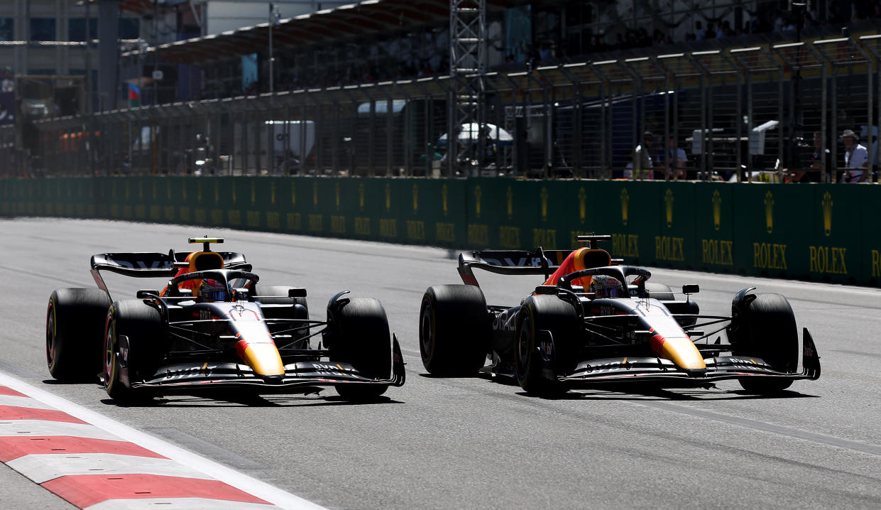 BAKU, AZERBAIJAN - JUNE 12: Max Verstappen of the Netherlands driving the (1) Oracle Red Bull Racing RB18 overtakes Sergio Perez of Mexico driving the (11) Oracle Red Bull Racing RB18 for the lead during the Formula 1 Grand Prix of Azerbaijan at Baku City Circuit on June 12, 2022 in Baku, Azerbaijan. (Photo by Peter Fox/Getty Images)