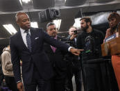 In this photo provided by The Metropolitan Transportation Authority (MTA), Mayor Eric Adams, left, points to new portable weapon detectors during a news conference in New York, March 28, 2024. New York City officials announced a pilot program on Thursday to deploy portable gun scanners in the subway system, part of an effort to deter violence underground and to make the system feel safer. (Marc A. Hermann/Metropolitan Transportation Authority via AP)