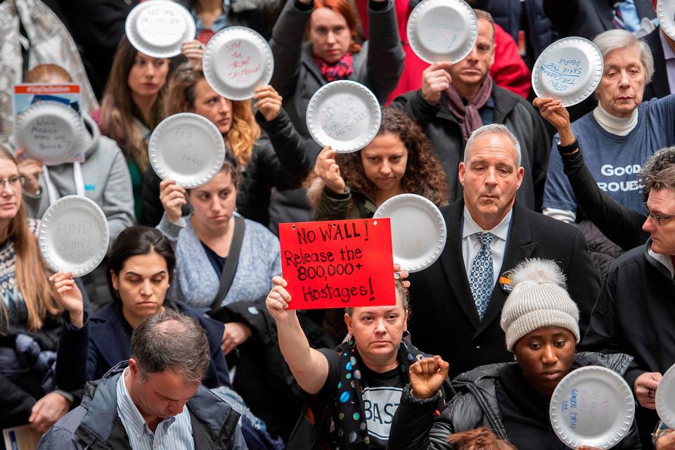 Federal employees holding empty plates stage a rally to call for a vote on the shutdown on Capitol Hill in Washington, DC, on Jan. 23, 2019. 