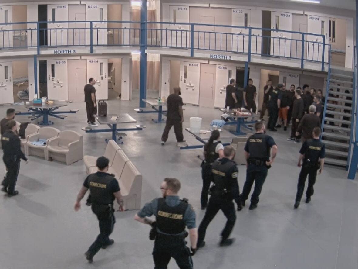 A still image from a video taken at the Central Nova Scotia Correctional Facility in Dartmouth, N.S., showing inmates and guards during an assault of a prisoner in one of the cells. (Nova Scotia court exhibit - image credit)