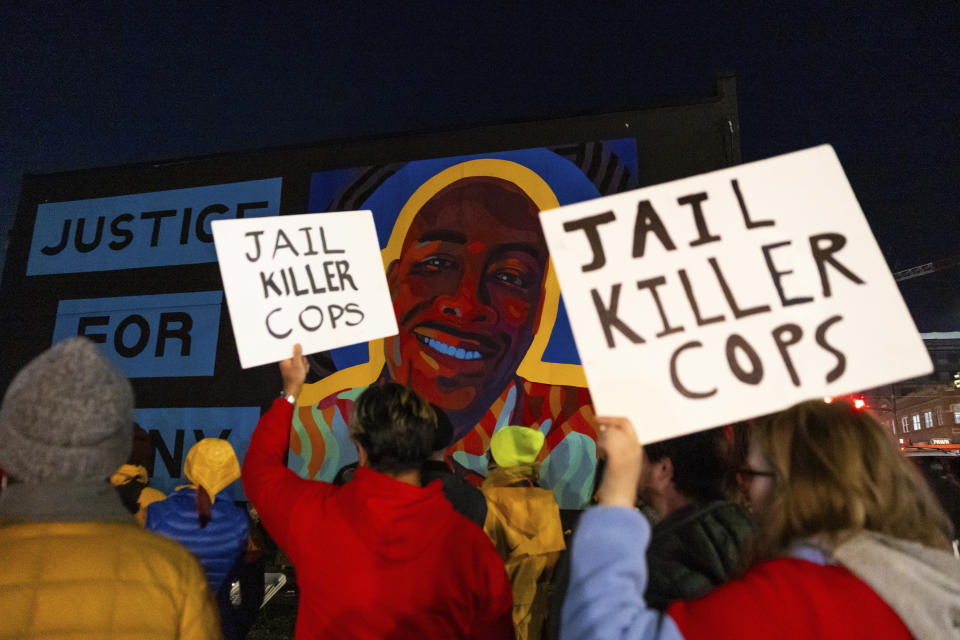 Protesters hold signs at a rally after the verdict was read during the trial of three Tacoma Police officers in the killing of Manny Ellis, at Pierce County Superior Court, Thursday, Dec. 21, 2023, in Tacoma, Wash. (AP Photo/Maddy Grassy)