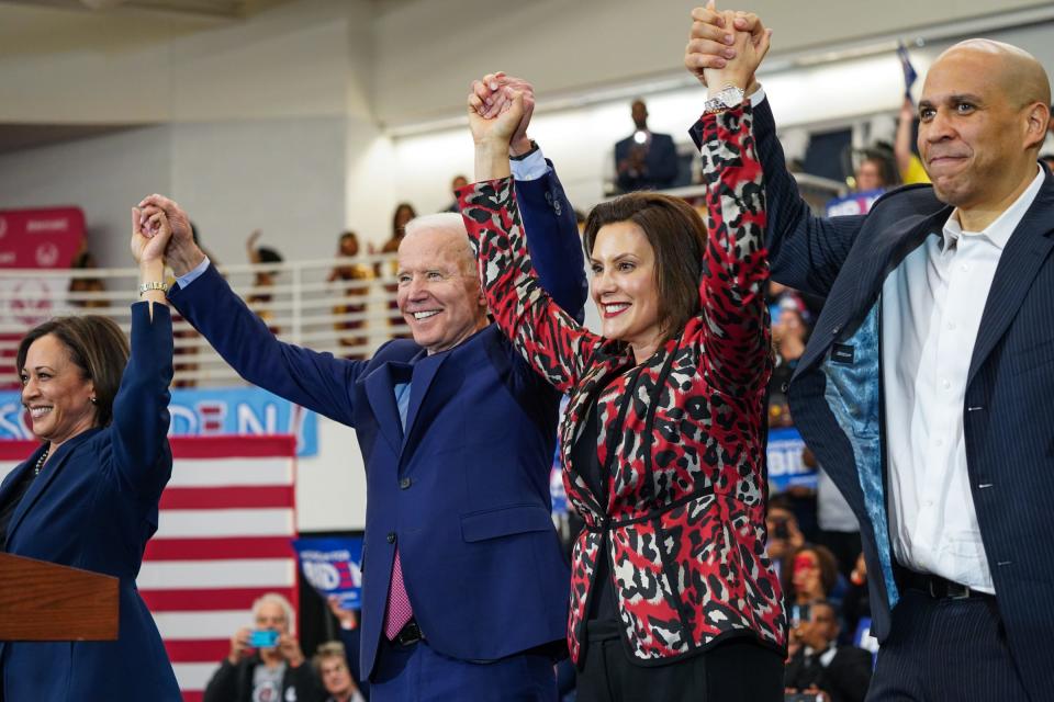 From left, U.S. Sen. Kamala Harris of California, Democratic presidential candidate and former Vice President Joe Biden, Michigan Governor Gretchen Whitmer and U.S. Sen. Cory Booker raise arms after Biden takes the stage to speak to a crowd during a Get Out the Vote event at Renaissance High School in Detroit on Monday, March 9, 2020.