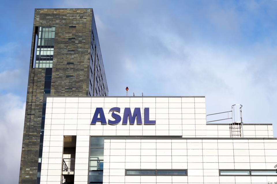 The outside of a white building with the letters ASML on it.