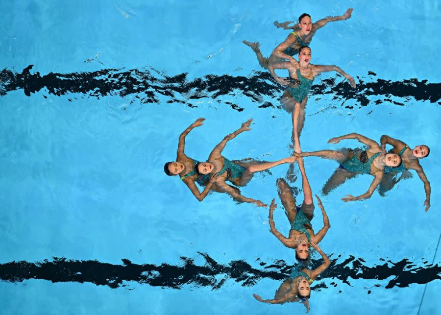 TOPSHOT – USA’s team compete in the final of the team free artistic swimming event during the 2024 World Aquatics Championships at Aspire Dome in Doha on February 9, 2024. (Photo by MANAN VATSYAYANA / AFP) (Photo by MANAN VATSYAYANA/AFP via Getty Images)