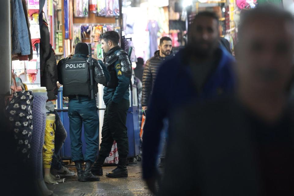 Iran's riot police forces stand in Tehran Bazaar (Reuters)