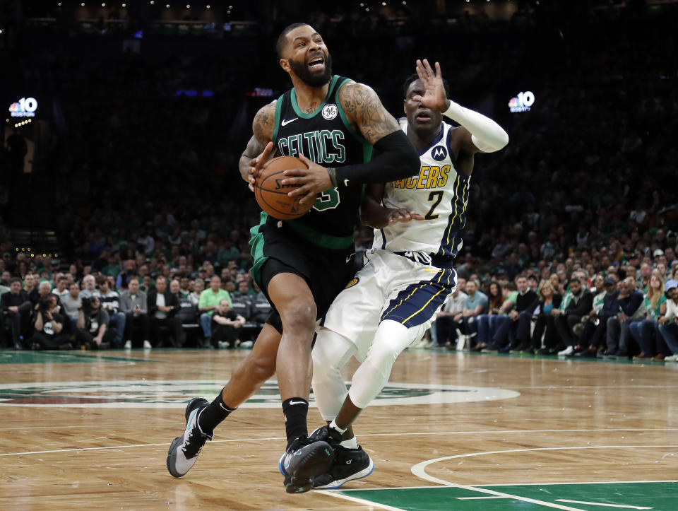 Boston Celtics' Marcus Morris, left, drives past Indiana Pacers' Darren Collison during the second quarter in Game 1 of a first-round NBA basketball playoff series, Sunday, April 14, 2019, in Boston. (AP Photo/Winslow Townson)