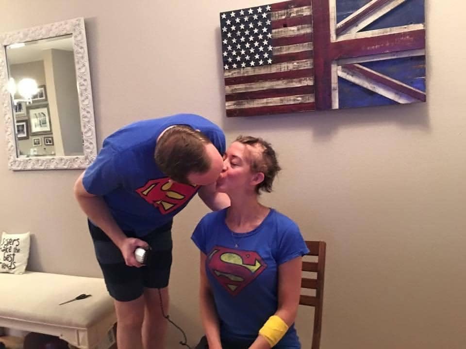 Nick and Katie kiss in matching Superman t-shirts as Nick shaves Katie's head.