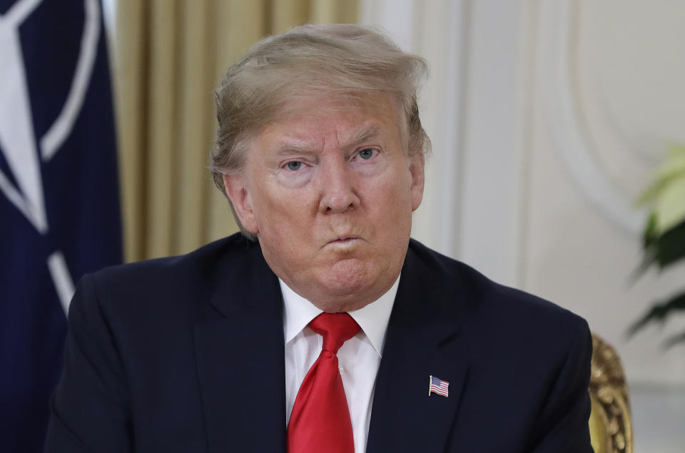 U.S. President Donald Trump grimaces during a meeting with NATO Secretary General, Jens Stoltenberg at Winfield House in London, Tuesday, Dec. 3, 2019. US President Donald Trump will join other NATO heads of state at Buckingham Palace in London on Tuesday to mark the NATO Alliance's 70th birthday. (AP Photo/Evan Vucci)
