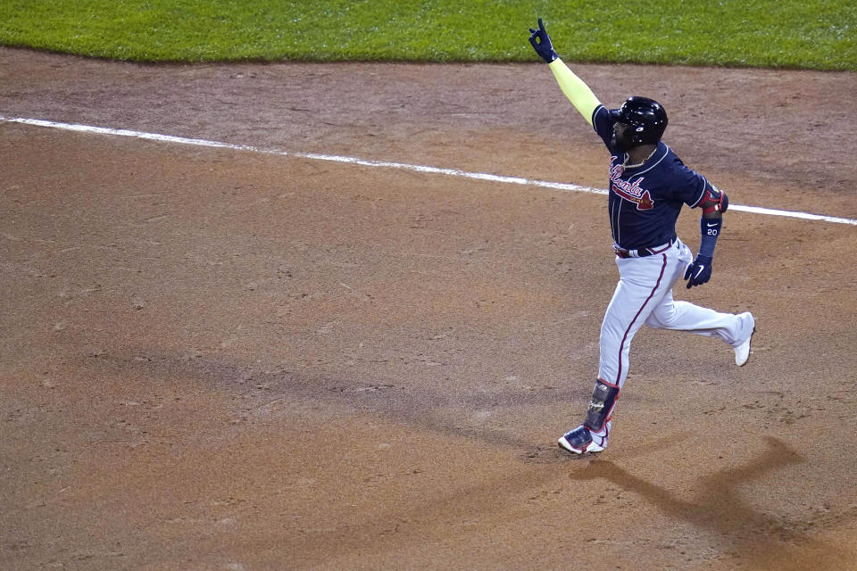 Atlanta Braves designated hitter Marcell Ozuna raises his arm as he rounds the bases on his solo home run in the seventh inning of a baseball game against the Boston Red Sox, Wednesday Sept. 2, 2020, in Boston. (AP Photo/Charles Krupa)