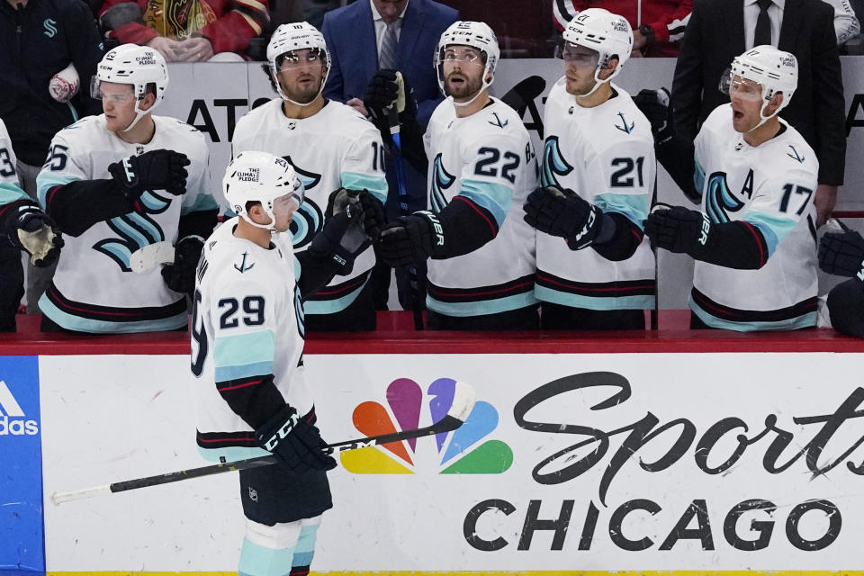 Seattle Kraken defenseman Vince Dunn (29) celebrates with teammates after scoring a goal during the second period of an NHL hockey game against the Chicago Blackhawks in Chicago, Sunday, Oct. 23, 2022. (AP Photo/Nam Y. Huh)