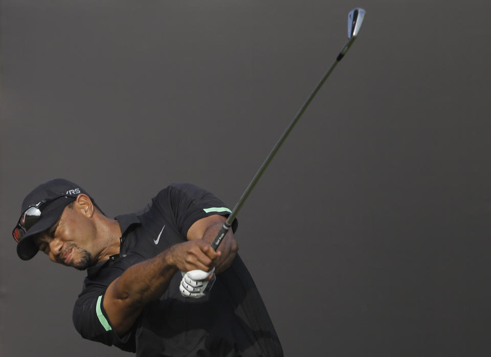 Tiger Woods from the U.S. tees off on the 15th hole during the second round of the Dubai Desert Classic golf tournament in Dubai, United Arab Emirates, Friday Jan. 31, 2014. (AP Photo/Kamran Jebreili)