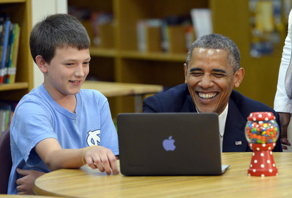 President Barack Obama smiles while watching a project of a seventh grade students as he tours Mooresville Middle School in Mooresville, North Carolina, on June 6, 2013. Obama arrived in North Carolina as part of his Middle Class Jobs 