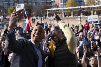 Sen. Cory Booker, D-NJ, shoots a selfie video with Sen. Raphael Warnock, D-Ga., during a rally in Sandy Springs, Ga., on Saturday, Nov. 26, 2022. Georgia counties will be allowed to hold early voting this Saturday in the U.S. Senate runoff election between Warnock and Republican challenger Herschel Walker.(AP Photo/Ben Gray)