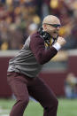FILE - In this Nov. 9, 2019, photo, Minnesota head coach P.J. Fleck cheers his team during an NCAA college football game against Penn Staten in Minneapolis. Fans of Minnesota's Golden Gophers are enjoying football success the team hasn't seen in decades, and daring to dream of a trip to Pasadena. (AP Photo/Stacy Bengs,File)