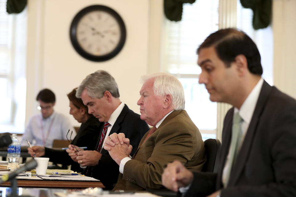 Martin P. Duffey, left, Christopher C. Fallon Jr., center, who are lawyers for Johnny Bobbitt, and Ernest E. Badway, right, who is the lawyer for the Kate McClure and Mark D'Amico, listen during a hearing on missing funds in the Johnny Bobbitt case in the Olde Historic Courthouse in Mt. Holly, NJ, Wednesday, Sept. 5, 2018. McClure and D'Amico are accused of mismanaging the money raised for Bobbitt. (David Maialetti/The Philadelphia Inquirer via AP, Pool)