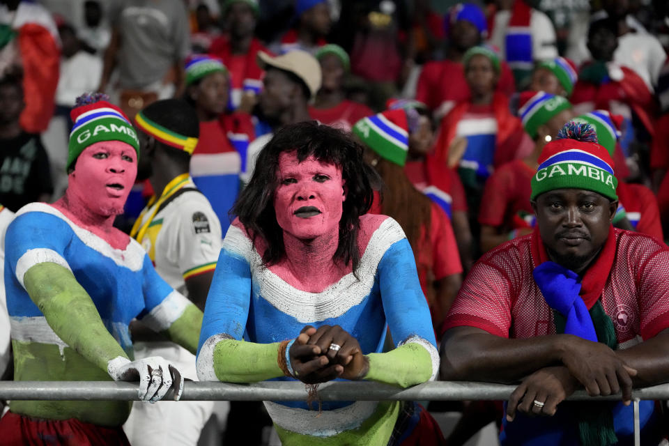 Gambia fans wait for the start for the African Cup of Nations Group C soccer match between Guinea and Gambia, at the Charles Konan Banny stadium in Yamoussoukro, Ivory Coast, Friday, Jan. 19, 2024. (AP Photo/Sunday Alamba)