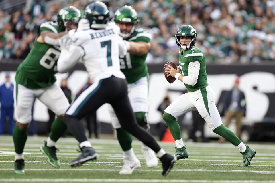 New York Jets quarterback Zach Wilson, right, looks to throw during the first half of an NFL football game against the Philadelphia Eagles, Sunday, Oct. 15, 2023, in East Rutherford, N.J. (AP Photo/Adam Hunger)