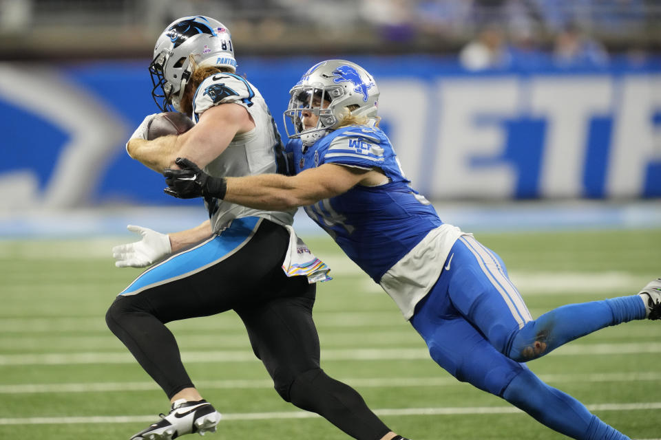 Carolina Panthers tight end Hayden Hurst carries as he is tackled by Detroit Lions linebacker Alex Anzalone in the second half of an NFL football game in Detroit, Sunday, Oct. 8, 2023. (AP Photo/Carlos Osorio)
