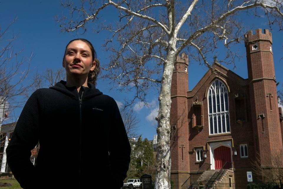 Sophia Redzinak stands along North Broad Street on Mar. 20, 2024, in Lancaster, Ohio. She was a part of the group from X Church who helped a Pickerington family clear debris from their home after a fatal fire occurred at their home.