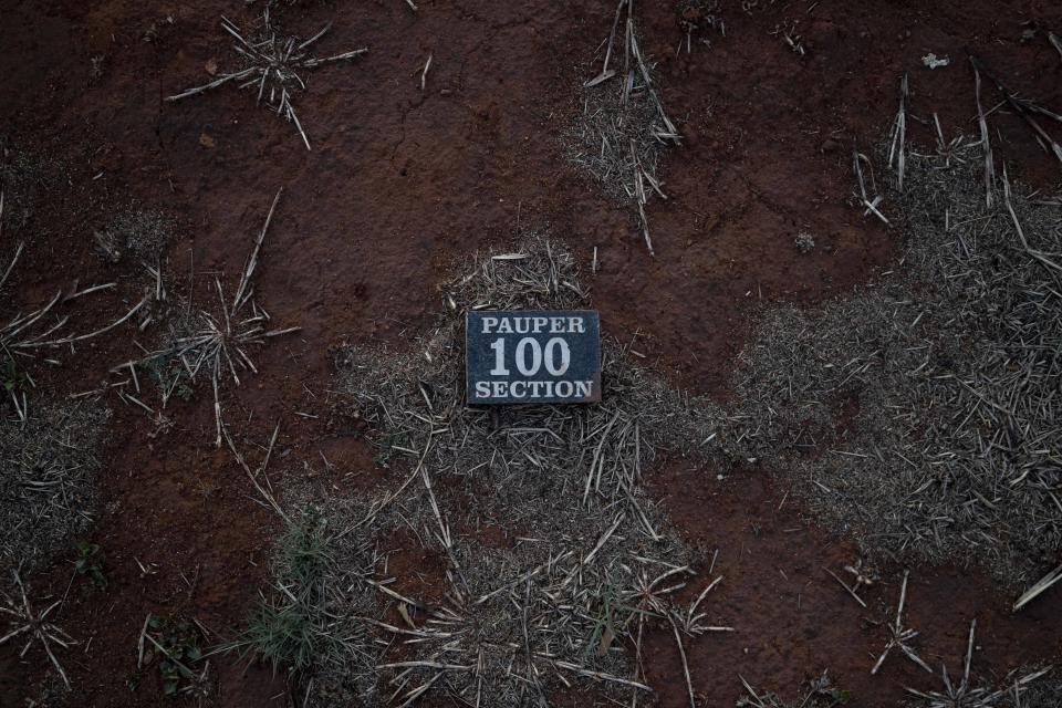 This Wednesday, Oct. 3, 2018 photo, shows the marker for a "pauper grave" at the Olifantsvlei cemetery outside Johannesburg. At least five bodies of unidentified people are buried in each grave. (AP Photo/Bram Janssen)