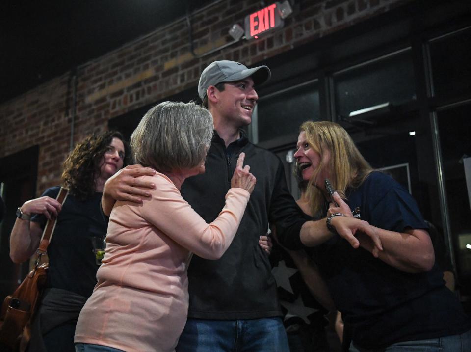 Debbie Helsley (left) helps congratulate Tyler Caviness alongside his mother, Crystal, on his win for municipal judge at their joint election party at Redbud Kitchen. Helsley won 71.1% of the vote in the race for city council, while Caviness won 61.5% in the race for municipal judge.
