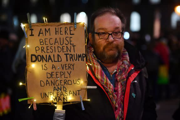 TOPSHOT - Demonstrators protest outside Downing Street against US President Donald Trump in central London on January 30, 2017. President Trump signed an executive order on January 27, 2016 restricting immigration from seven Muslim countries. / AFP / BEN STANSALL (Photo credit should read BEN STANSALL/AFP/Getty Images)