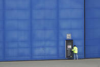 A worker opens a door at Boeing's manufacturing facility in Everett, Wash., Monday, March 23, 2020, north of Seattle. Boeing announced Monday that it will be suspending operations and production at its Seattle area facilities due to the spread of the new coronavirus. (AP Photo/Ted S. Warren)