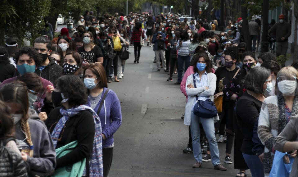 People line up for their turn to vote during a referendum to decide whether the country should replace its 40-year-old constitution, in Santiago, Chile, Sunday, Oct. 25, 2020.(AP Photo/Esteban Felix)