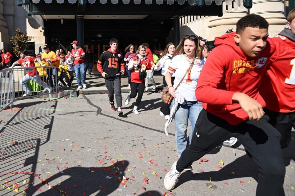 People flee after shots were fired near the Kansas City Chiefs' Super Bowl LVIII victory parade on Wednesday in Kansas City, Missouri. A shooting incident at a packed parade to celebrate the Kansas City Chiefs' Super Bowl victory killed one person and injured 22 others.