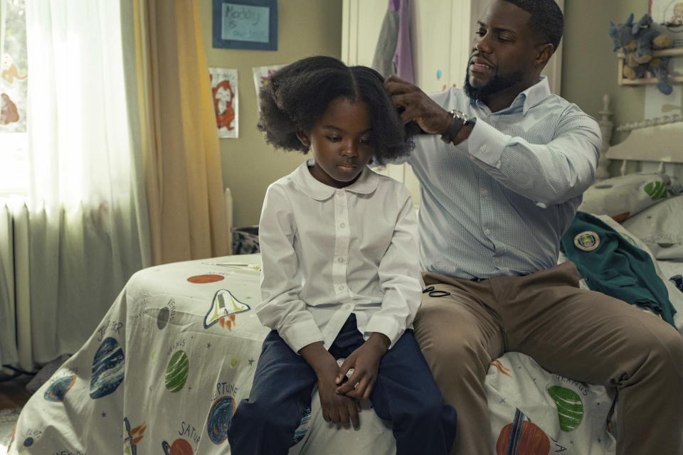 This image released by Netflix shows Melody Hurd, left, and Kevin Hart in a scene from "Fatherhood." (Philippe Bosse/Netflix via AP)