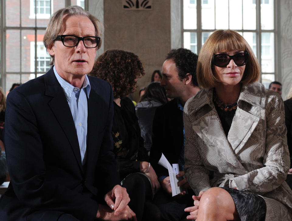 Anna and Bill sit side-by-side at a fashion show