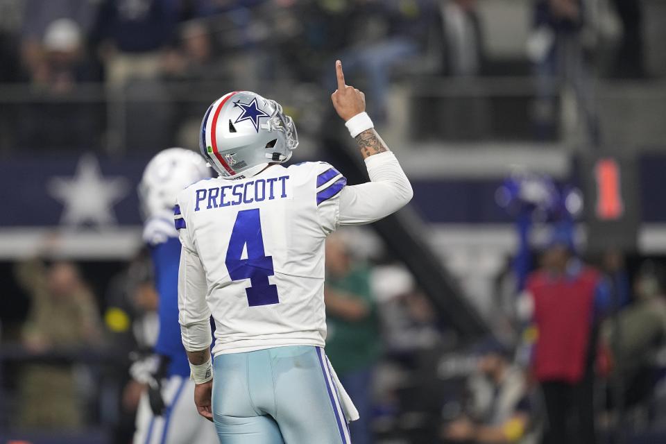 Dallas Cowboys' Dak Prescott (4) reacts after throwing a touchdown pass during the second half of an NFL football game against the Indianapolis Colts, Sunday, Dec. 4, 2022, in Arlington, Texas. (AP Photo/Tony Gutierrez)
