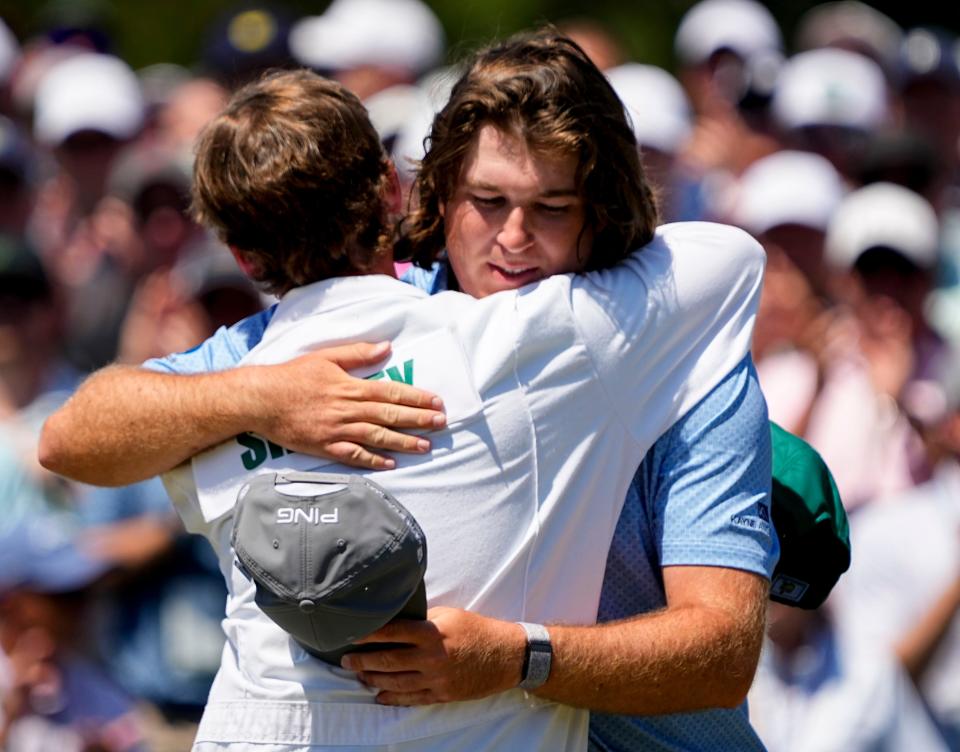 Neal Shipley hugs his caddie, Carter Pitcairn, after finishing his round.