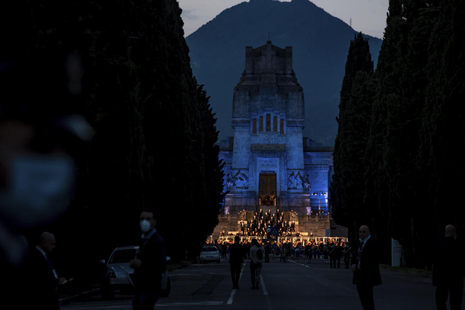 Musicians perform in front of the Bergamo cemetery, Italy, Sunday, June 28, 2020. Italy bid farewell to its coronavirus dead on Sunday with a haunting Requiem concert performed at the entrance to the cemetery of Bergamo, the hardest-hit province in the onetime epicenter of the outbreak in Europe. President Sergio Mattarella was the guest of honor, and said his presence made clear that all of Italy was bowing down to honor Bergamo’s dead, “the thousands of men and women killed by a sickness that is still greatly unknown and continues to threaten the world.” (Claudio Furlan/LaPresse via AP)