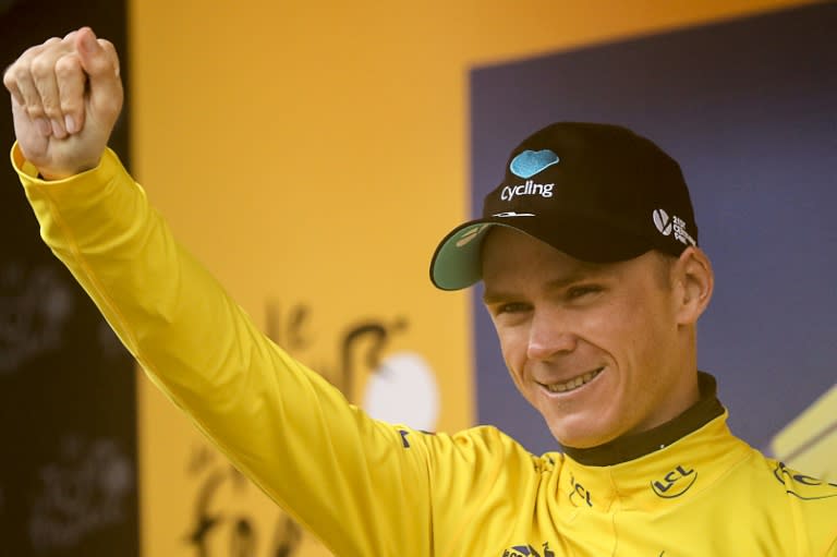 Britain's Chris Froome celebrates his overall leader's yellow jersey on the podium in Morzine, central france at the end of the 146,5 km twentieth stage of the 103rd Tour de France on July 23, 2016