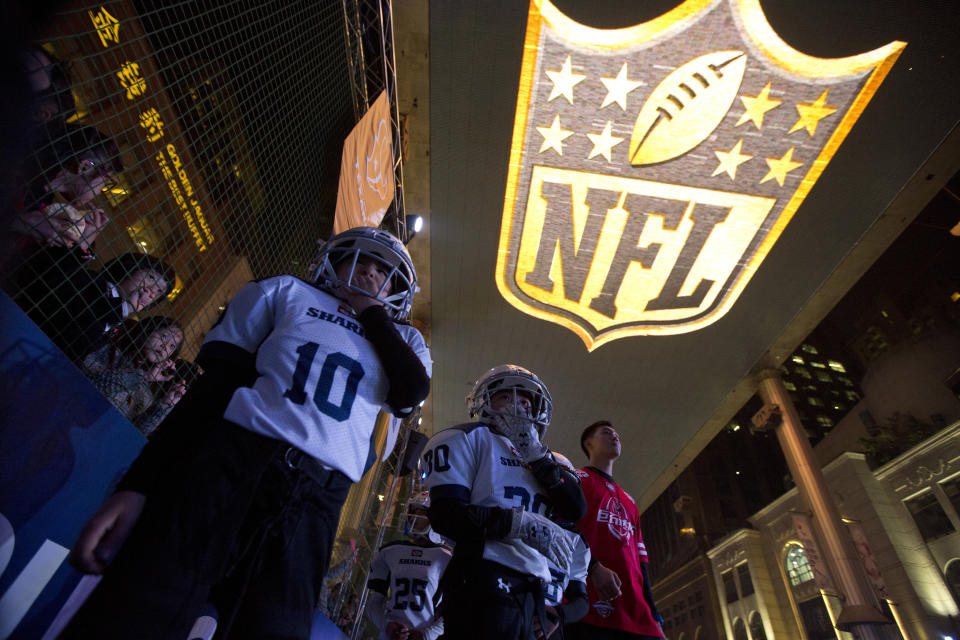 Youths take part in a football game at an NFL publicity event in Beijing. The NFL has been aggressively promoting football in China hoping to take advantage of rising income and growing taste for exotic foreign sports. (AP)