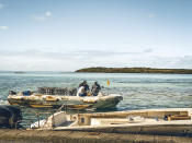 In this photo provided by Grégoire Rouxel people on a boat evaluate damage from fuel leaking from a ship off shore that ran aground in the ocean, Friday, Aug. 7, 2020, in Mauritius. The Indian Ocean island of Mauritius has declared a "state of environmental emergency" after a Japanese-owned ship that ran aground offshore days ago began spilling tons of fuel. Prime Minister Pravind Jugnauth announced the development late Friday, Aug. 7, as satellite images showed a dark slick spreading near environmental areas the government called "very sensitive." (@gregrouxel via AP)