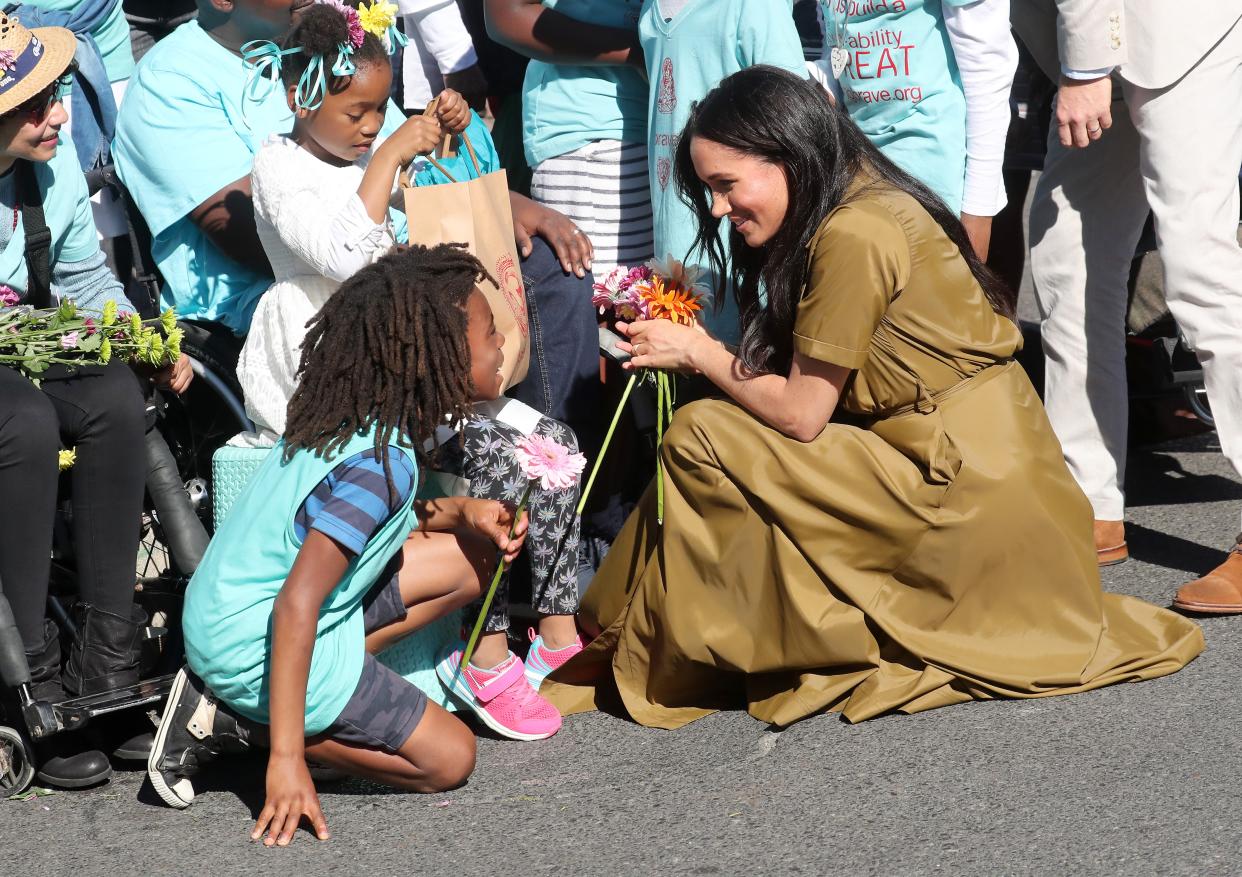 <p>CAPE TOWN, SOUTH AFRICA - SEPTEMBER 24: Meghan, Duchess of Sussex meets a young wellwisher as she and Prince Harry, Duke of Sussex  walk through the colourful and multicultural neighbourhood of Bo-Kaap on Heritage Day during their royal tour of South Africa on September 24, 2019 in Cape Town, South Africa. </p> ((Photo by Chris Jackson/Getty Images))