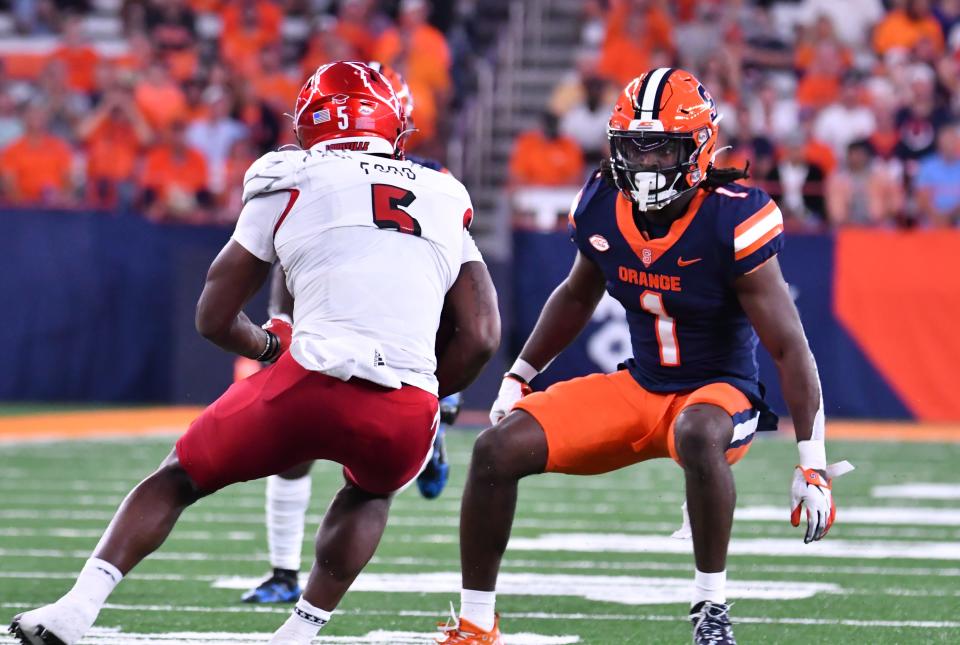 Sep 3, 2022; Syracuse, New York, USA; Syracuse Orange defensive back Ja'Had Carter (1) prepares to tackle Louisville Cardinals tight end Marshon Ford (5) in the second quarter at JMA Wireless Dome. Mandatory Credit: Mark Konezny-USA TODAY Sports