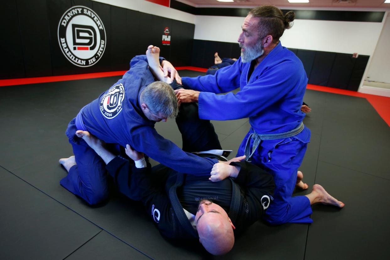 Danny Savery monitors TJ McGoff and Andrew Quintin as they work on their forms at the new Danny Savery Brazilian Jiu-Jitsu on Sarah's Way in Fairhaven.