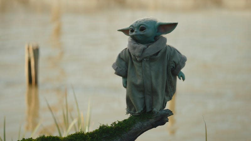 grogu standing on a branch