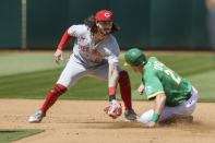Cincinnati Reds second baseman Jonathan India, left, tags out Oakland Athletics' Conner Capel in a failed steal attempt during the fifth inning of a baseball game in Oakland, Calif., Saturday, April 29, 2023. (AP Photo/John Hefti)