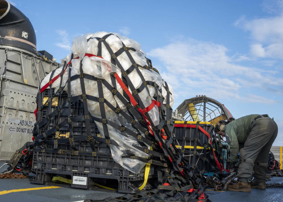 Sailors assigned to Assault Craft Unit 4 prepare material recovered in the Atlantic Ocean from a high-altitude balloon for transport to federal agents at Joint Expeditionary Base Little Creek Feb. 10, 2023.  / Credit: U.S. Navy photo by Mass Communication Specialist 1st Class Ryan Seelbach