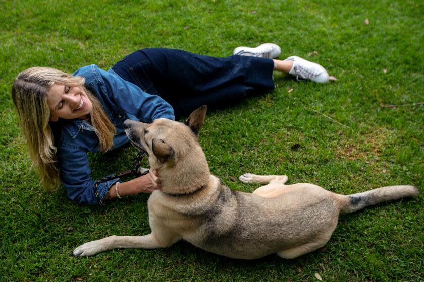 A portrait of Michelle Madden with her dog Buddy at San Rafael Park.