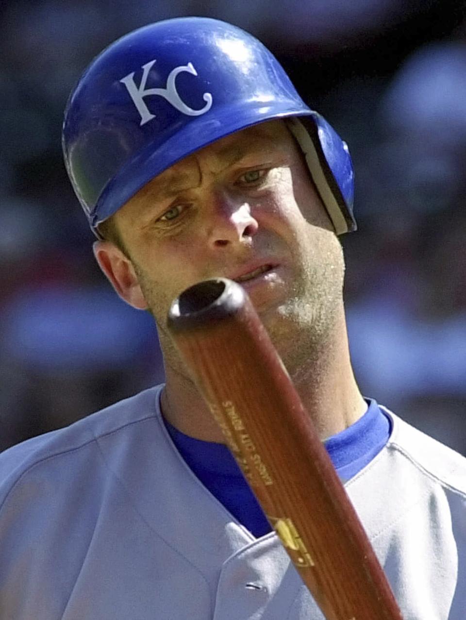 FILE - Kansas City Royals batter Dave McCarty inspects his bat after hitting a foul ball during the seventh inning against the Texas Rangers in a baseball game in Arlington, Texas, May 31, 2001. McCarty, a member of the Boston Red Sox championship team in 2004 who played with seven MLB teams in an 11-year career, has died. He was 54. The Red Sox announced McCarty's death in a statement, saying the former first baseman and outfielder died Friday, April 19, 2024, after suffering a cardiac event in Oakland, Calif. (AP Photo/Bill Janscha, File)